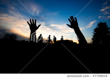 Silhouette of hands at sunset sky. Silhouette of hands at sunset sky. 47799934