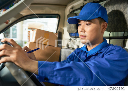 Delivery man checking addresses Delivery man checking addresses 47800191