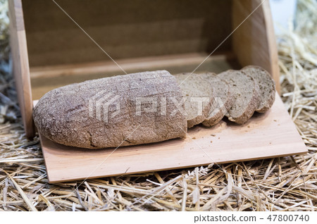 rye bread in wood bin on straw 47800740