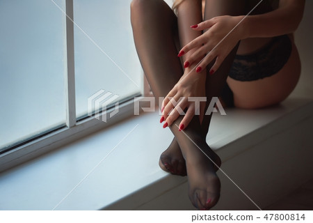 Black stockings and red nails. Black stockings and red nails. 47800814