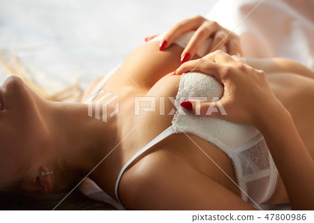 Woman touching breasts close up. 47800986