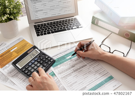 Accountant working with Polish tax forms Accountant working with Polish tax forms 47802167