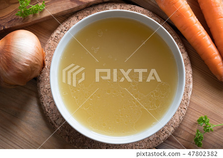 Bone broth made from chicken served in a plate 47802382