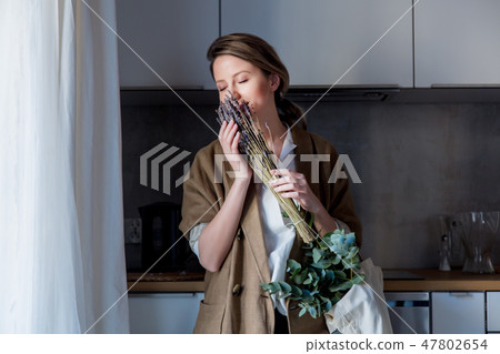 girl holding a bouquet of lavender and a rag bag 47802654