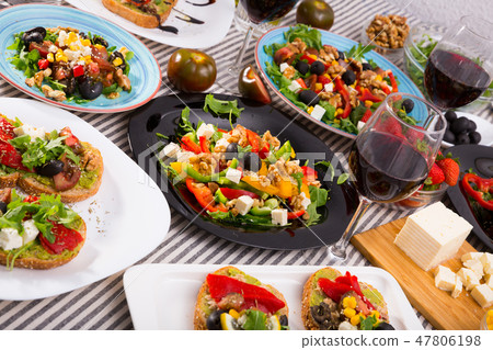 Vegetarian salads and sandwiches on dining table Vegetarian salads and sandwiches on dining table 47806198