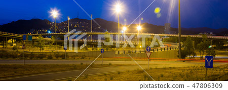 Panorama of city highway in dusk with blurred headlights Panorama of city highway in dusk with blurred headlights 47806309