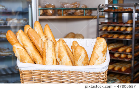 Baked baguettes in wicker basket 47806687