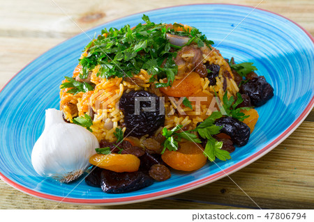 Lamb pilau with dried fruits and greens 47806794