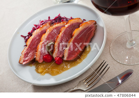Delicious baked on sauce duck breast Magre with caramelized onions and cabbage Delicious baked on sauce duck breast Magre with caramelized onions and cabbage 47806844