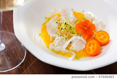 Seafood ceviche from horse-mackerel with spicy avocado sauce, greens and cumquat 47806865