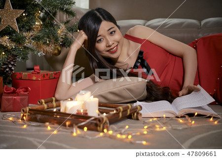Woman reading on winter night 47809661
