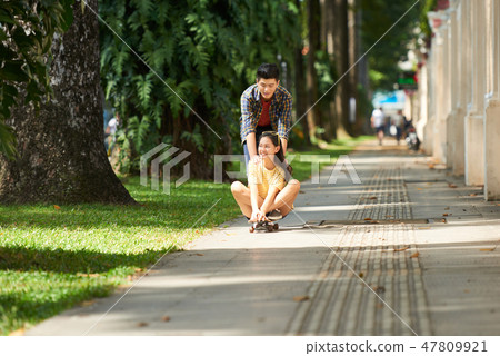 Couple riding on skateboard 47809921
