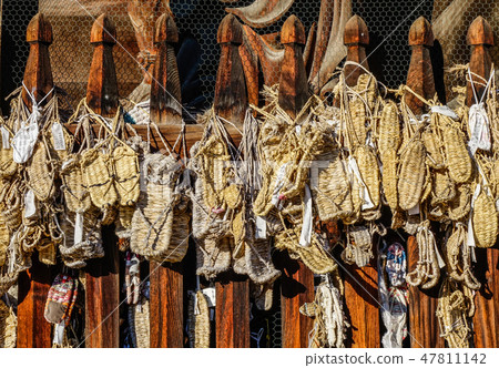 Hanging grass slippers at ancient temple Hanging grass slippers at ancient temple 47811142