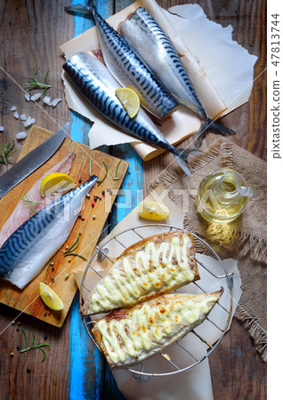 Fresh and grilled mackerel on the board. 47813744