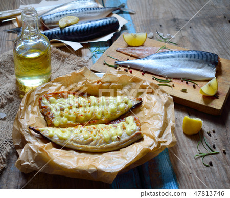 Fresh and grilled mackerel on the board. 47813746