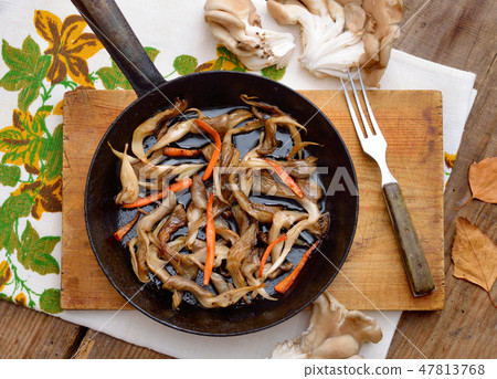 Fried oyster mushroom on a frying pan. Fried oyster mushroom on a frying pan. 47813768