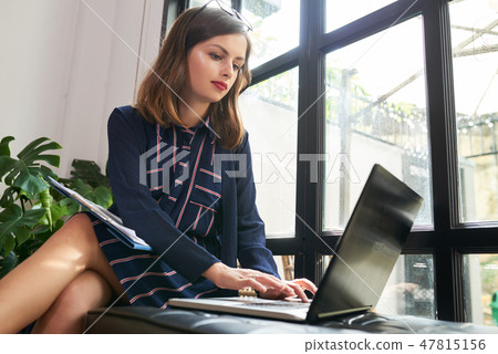 Female entrepreneur working on laptop Female entrepreneur working on laptop 47815156