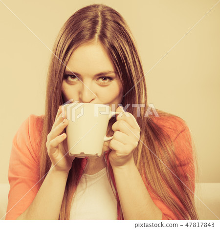 Woman drinking hot coffee beverage. Caffeine. Woman drinking hot coffee beverage. Caffeine. 47817843
