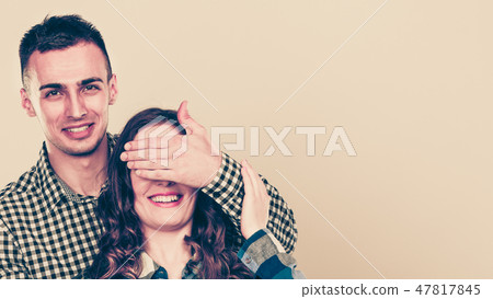 Man covering woman eyes for surprise. Man covering woman eyes for surprise. 47817845