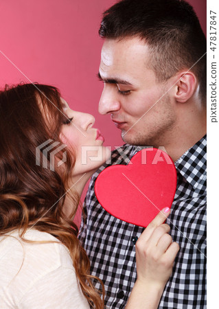 Loving couple kissing behind red heart. Love. 47817847