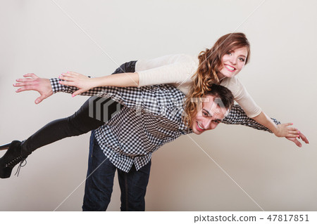 Woman riding piggyback on man. Happy couple. Woman riding piggyback on man. Happy couple. 47817851