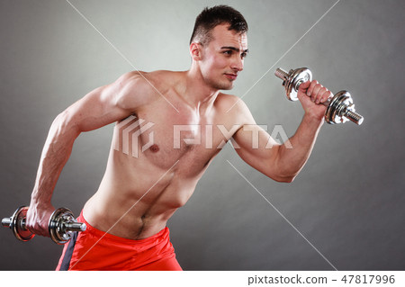 athletic man working with heavy dumbbells 47817996