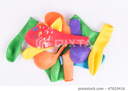 Colorful deflated balloons on white background Colorful deflated balloons on white background 47820416