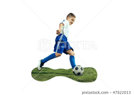 Young boy kicks the soccer ball 47822013