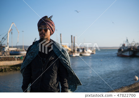 Young Asian Bearded Tourist man with Dreadlocks and scarf on head Enjoying Essaouira, Morocco at the Young Asian Bearded Tourist man with Dreadlocks and scarf on head Enjoying Essaouira, Morocco at the 47822700