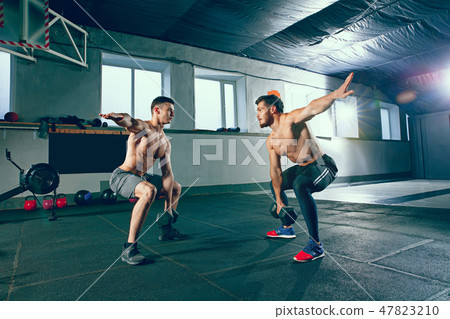 Athletic man doing exercise for arms. 47823210