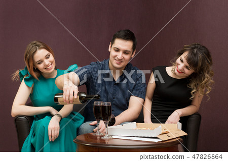One man in company of two women party, alcohol. One man in company of two women party, alcohol. 47826864