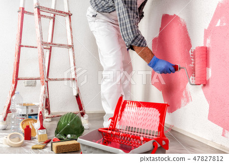 house painter at work painting the wall 47827812
