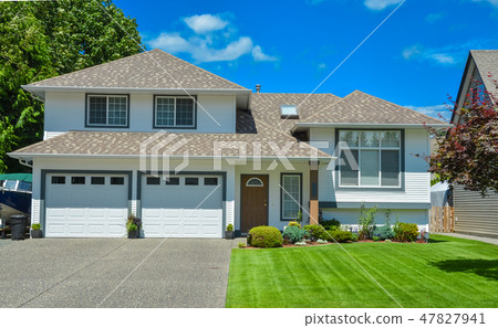 Nice lawn and entrance of beautiful residential house on sunny day 47827941