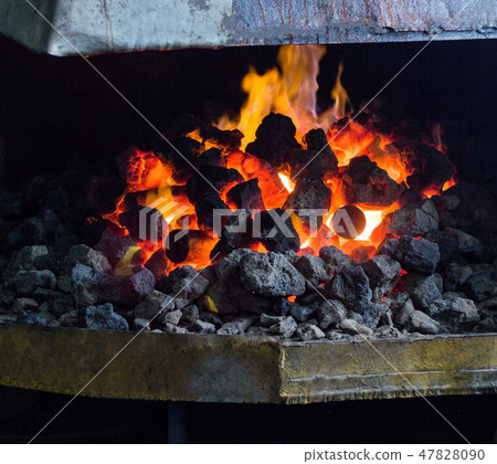 Fiery furnace with coal and hot metal parts for further processing, old forge, cooker Fiery furnace with coal and hot metal parts for further processing, old forge, cooker 47828090