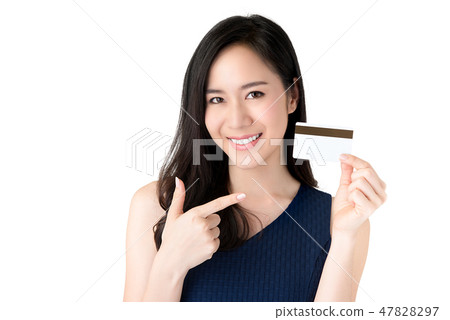 Smiling Asian woman presenting credit card in hand Smiling Asian woman presenting credit card in hand 47828297