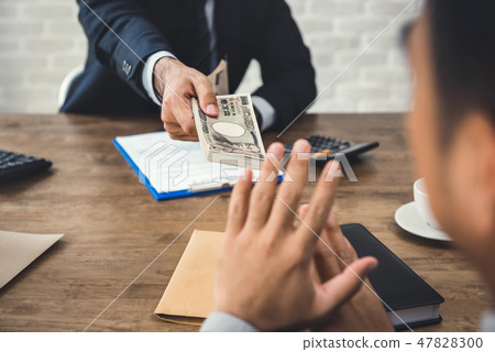 Businessman rejecting money bribery from partner Businessman rejecting money bribery from partner 47828300