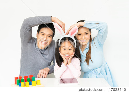 Happy young Asian family doing funny pose together Happy young Asian family doing funny pose together 47828540