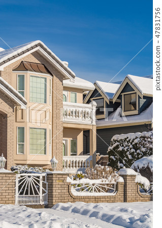 Facade of new luxury houses in snow on blue sky background on winter season Facade of new luxury houses in snow on blue sky background on winter season 47831756