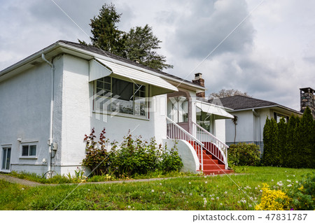 Entrance of residential house with concrete pathway over the front yard Entrance of residential house with concrete pathway over the front yard 47831787