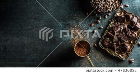 Dark chokolate cocoa beans and powder on concrete table 47836855