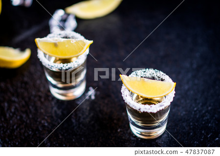 Tequila with lemon and lime Tequila with lemon and lime 47837087