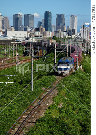EF210 freight train going through an urban oasis EF210 freight train going through an urban oasis 47837932
