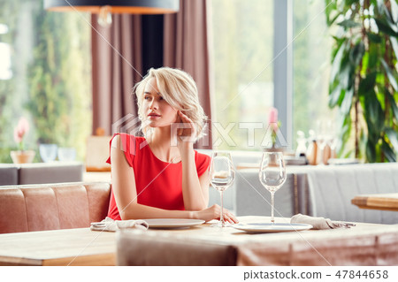 Young woman on date in restaurant sitting looking aside sensual 47844658