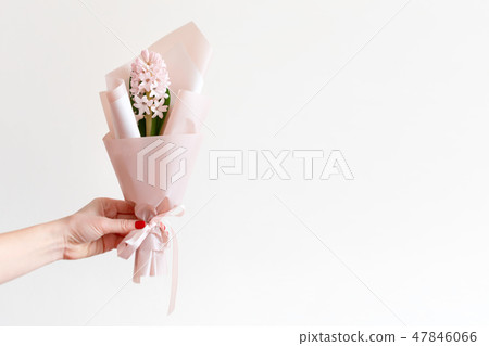 Woman hand with manicure holding spring flowers. Fresh bouquet with hyacinth. Copyspace for text 47846066