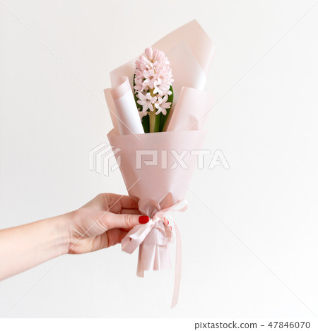 Woman hand with manicure holding spring flowers. Fresh bouquet with hyacinth. Copyspace for text 47846070
