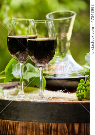 Red wine bottle and wine glass on wodden barrel. Red wine bottle and wine glass on wodden barrel. 47848998