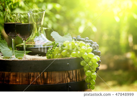 Red wine bottle and wine glass on wodden barrel. Red wine bottle and wine glass on wodden barrel. 47848999
