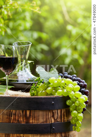 Red wine bottle and wine glass on wodden barrel. Red wine bottle and wine glass on wodden barrel. 47849000