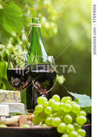 Old wooden barrel with bottle and glass 47849008