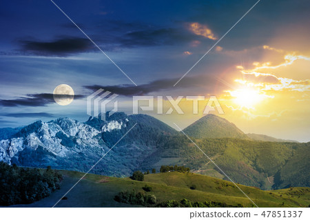 time change above mountains with rocky formations 47851337